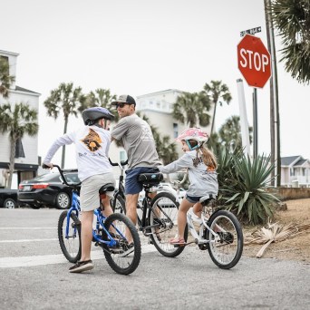a group of people riding on the back of a bicycle