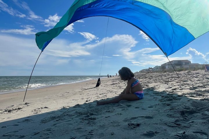 an umbrella sitting on top of a beach