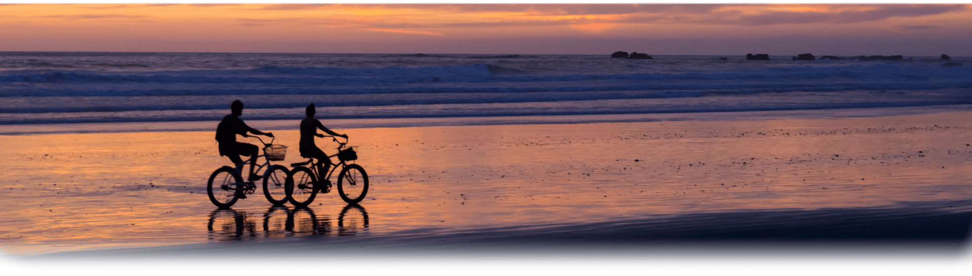 a person riding a bicycle next to a body of water